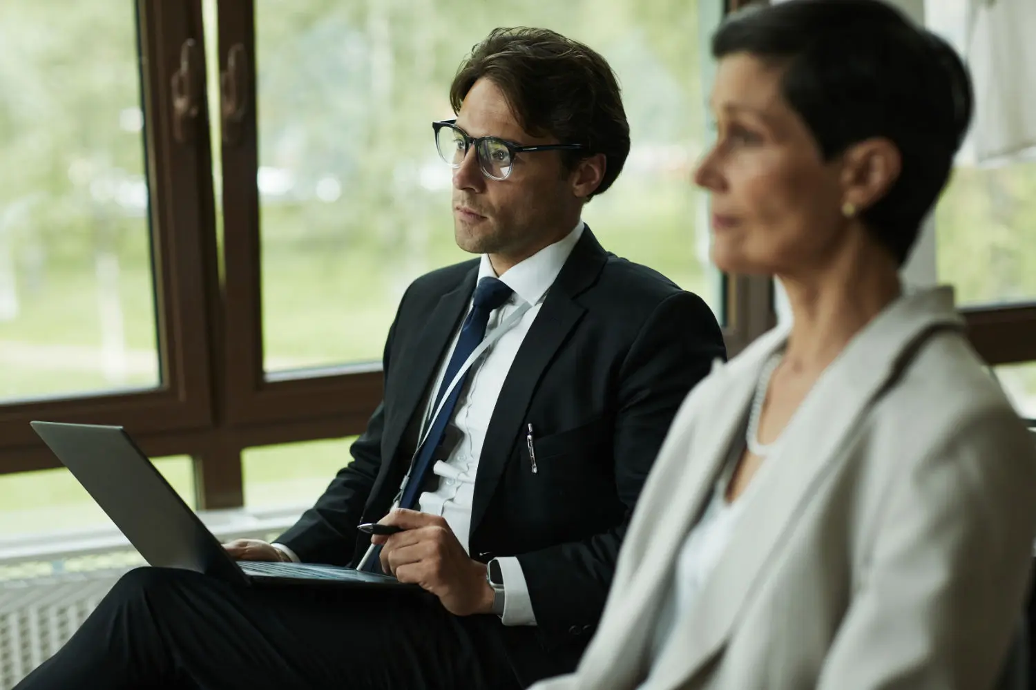 caucasian-young-man-female-colleague-attending-business-meeting
