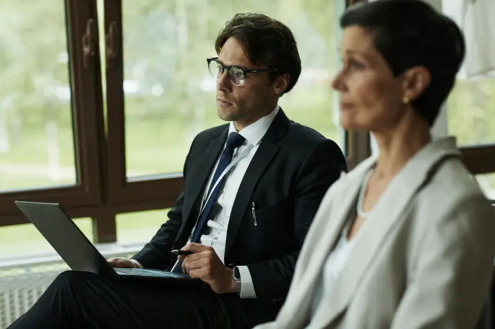 caucasian-young-man-female-colleague-attending-business-meeting