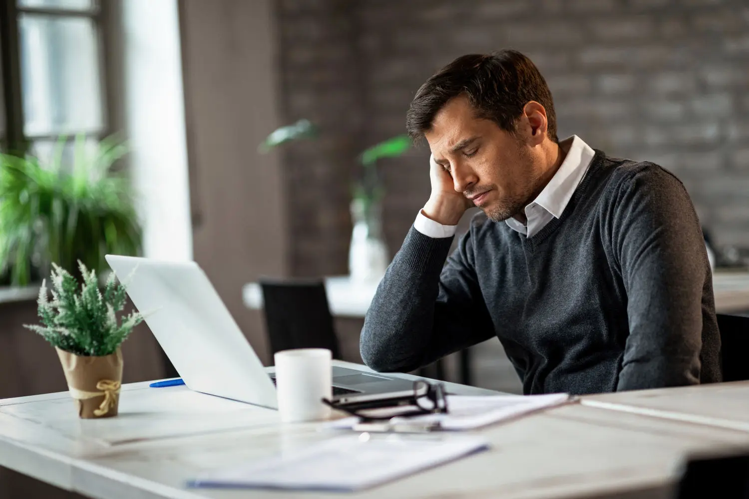 exhausted-businessman-resting-with-eyes-closed-his-office-desk-while-feeling-tired-work