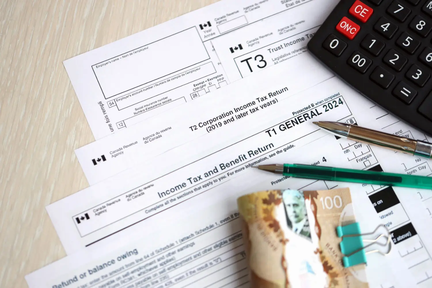 many-blank-canadian-tax-forms-lies-table-with-canadian-money-bills-calculator-pen-close-up