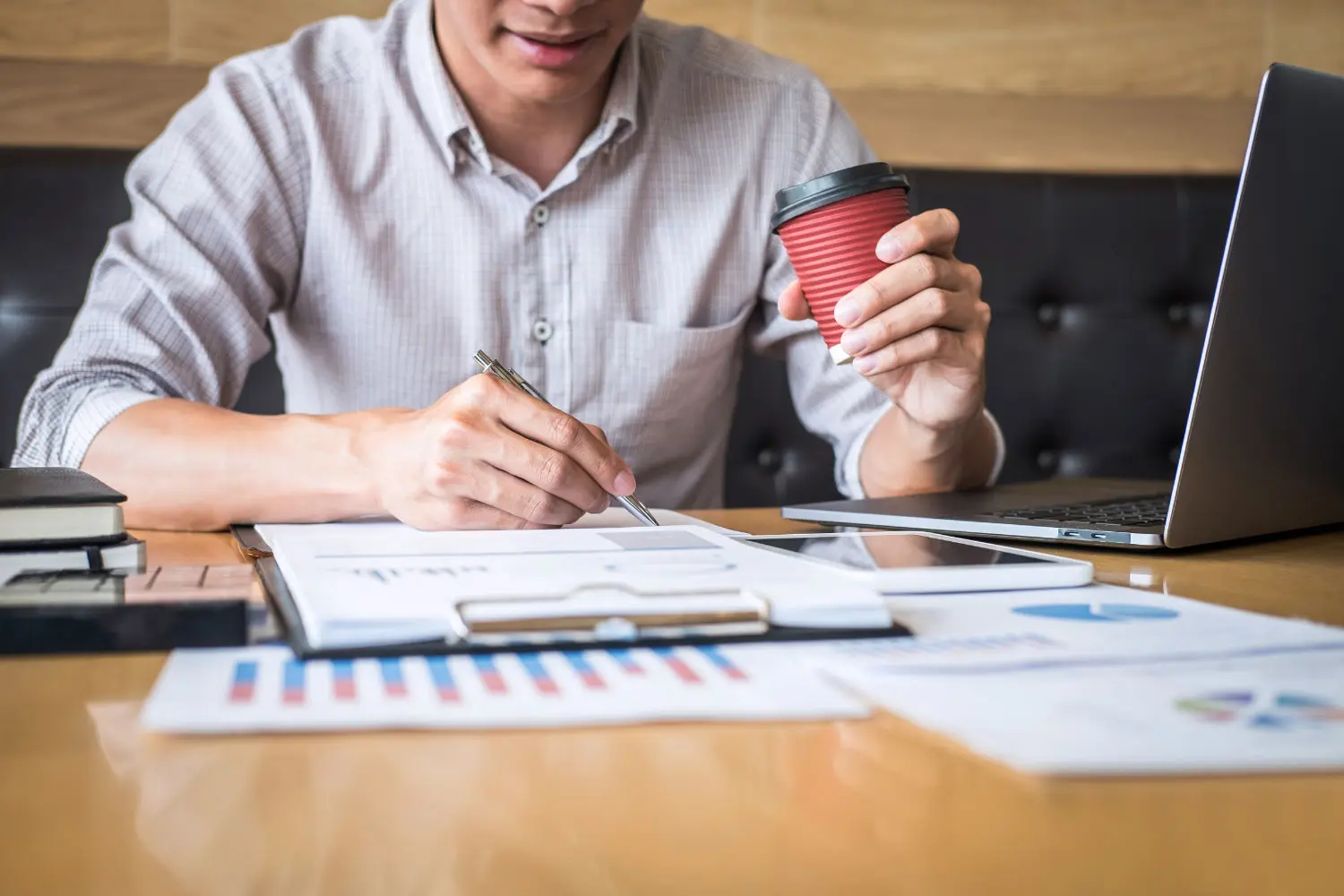 midsection-businessman-working-desk-office