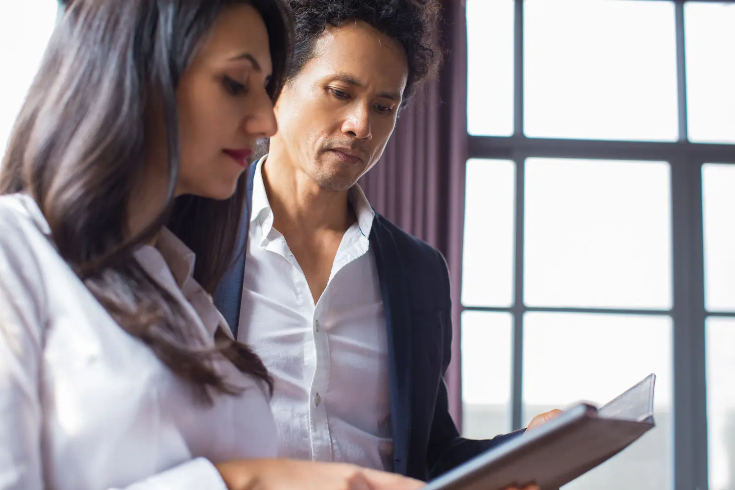 thoughtful-business-executives-examining-report
