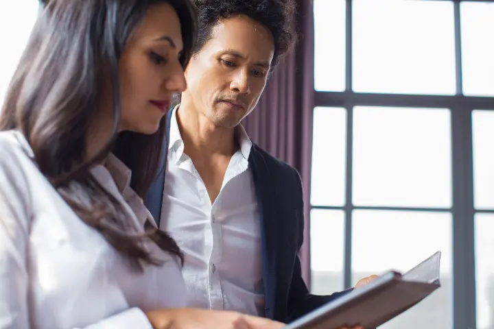 thoughtful-business-executives-examining-report